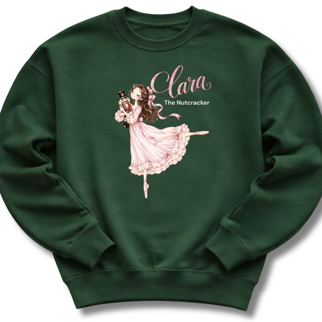 A forest green youth crewneck sweatshirt featuring an illustration of Clara in a graceful pink ballet pose with delicate 'The Nutcracker' lettering.