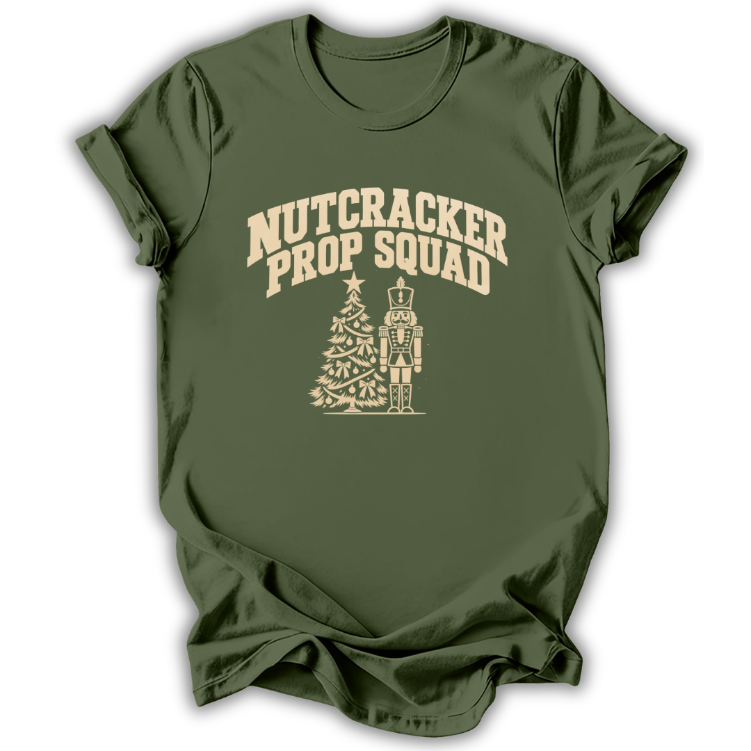A military green short-sleeve t-shirt printed with the “Nutcracker Prop Squad” graphic design.
