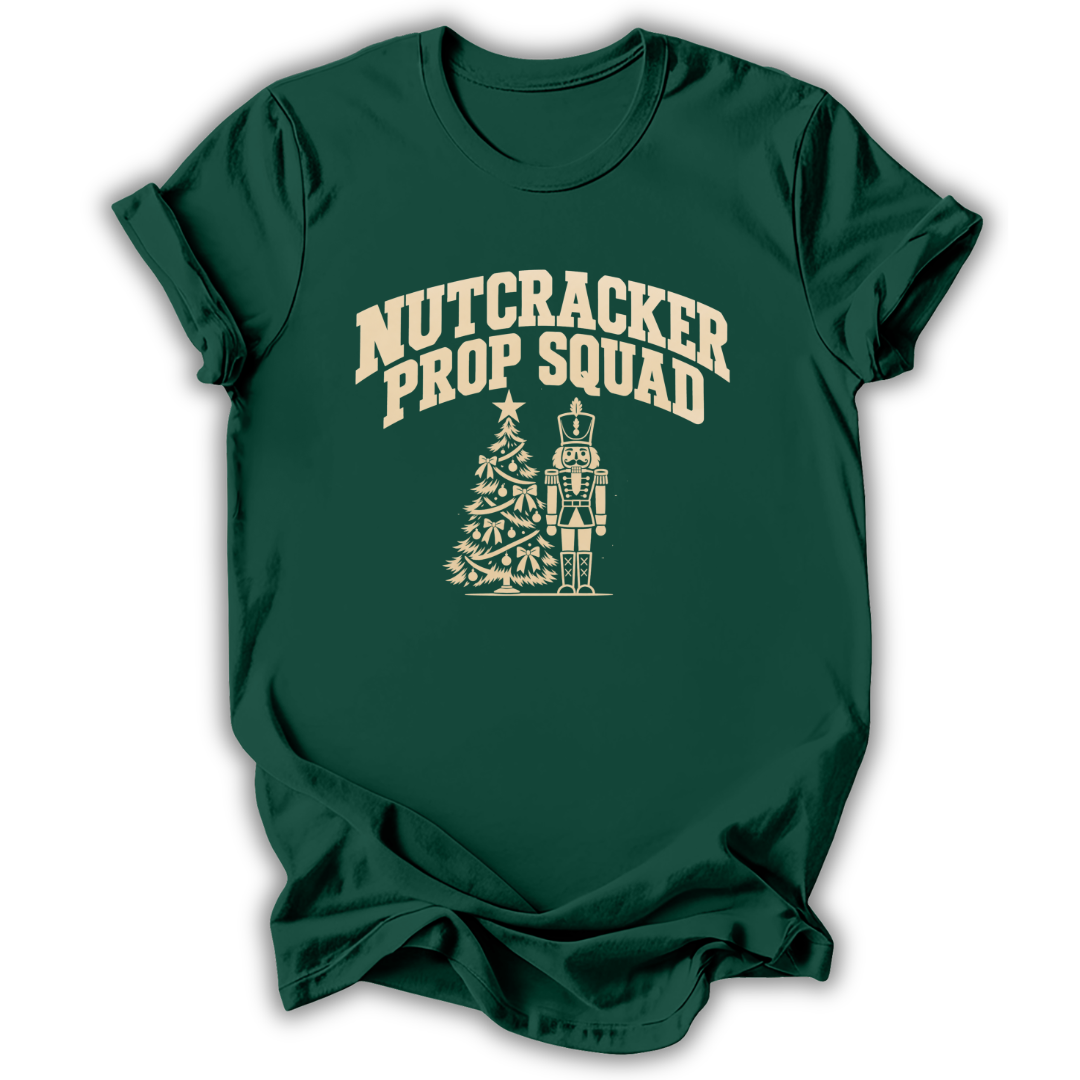 A forest green short-sleeve t-shirt printed with the “Nutcracker Prop Squad” graphic design.