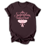A dark chocolate brown short-sleeve t-shirt printed with the “Sugarplum Support Staff” Nutcracker graphic design.