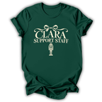 A forest green short-sleeve t-shirt printed with the “Clara Support Staff” Nutcracker graphic design.