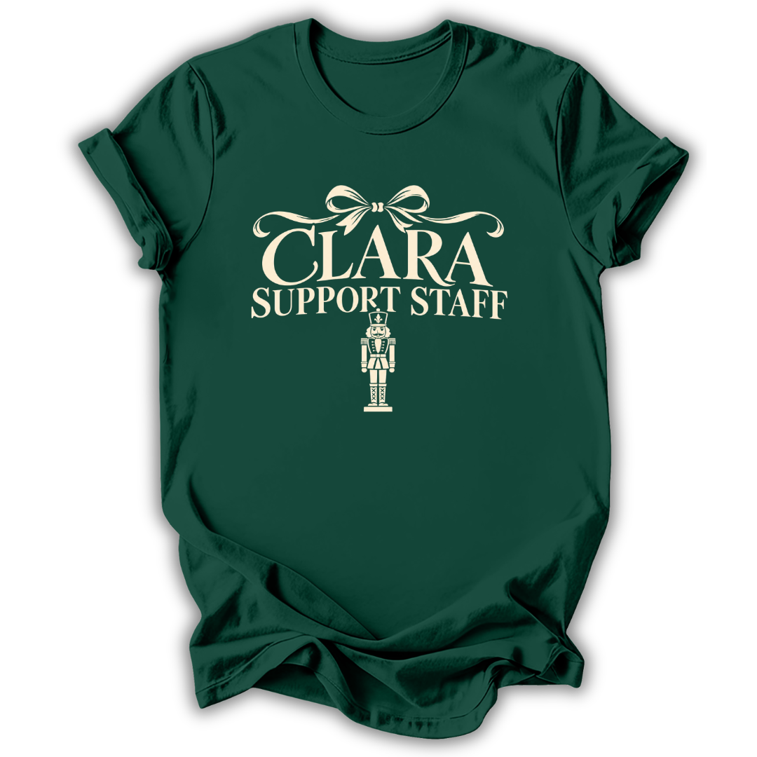 A forest green short-sleeve t-shirt printed with the “Clara Support Staff” Nutcracker graphic design.