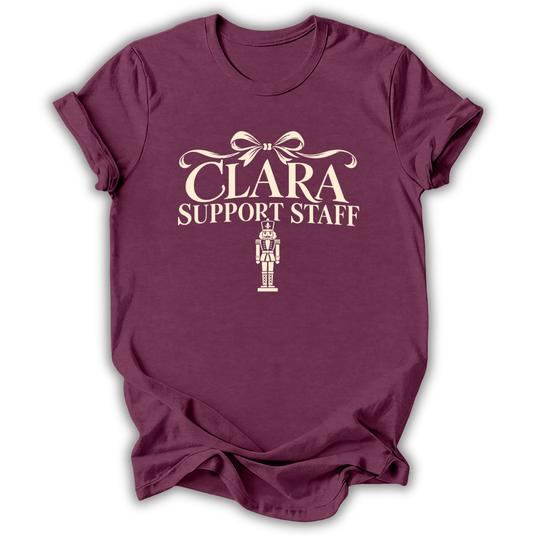 A heather maroon short-sleeve t-shirt printed with the “Clara Support Staff” Nutcracker graphic design.