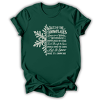 A forest green short-sleeve t-shirt printed with the “Nutcracker Snowflakes” graphic design.