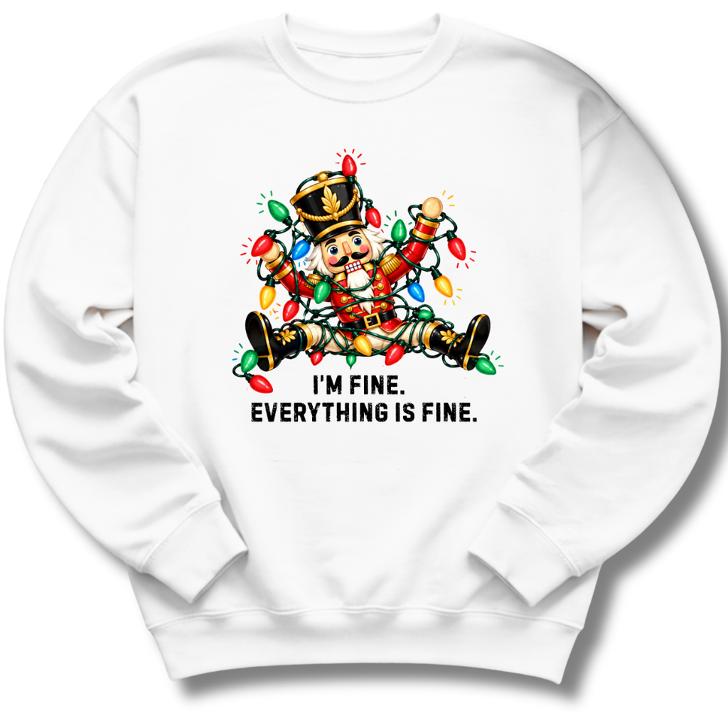 A white crewneck sweatshirt featuring a colorful nutcracker tangled in Christmas lights beneath the words 'I'm fine. Everything's fine.'
