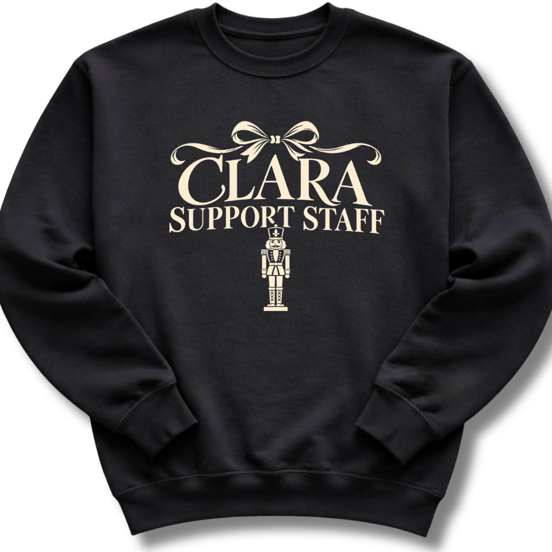A black crewneck sweatshirt featuring a 'Clara Support Staff' Nutcracker graphic.