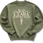 A military green crewneck sweatshirt featuring a 'Clara Support Staff' Nutcracker graphic.