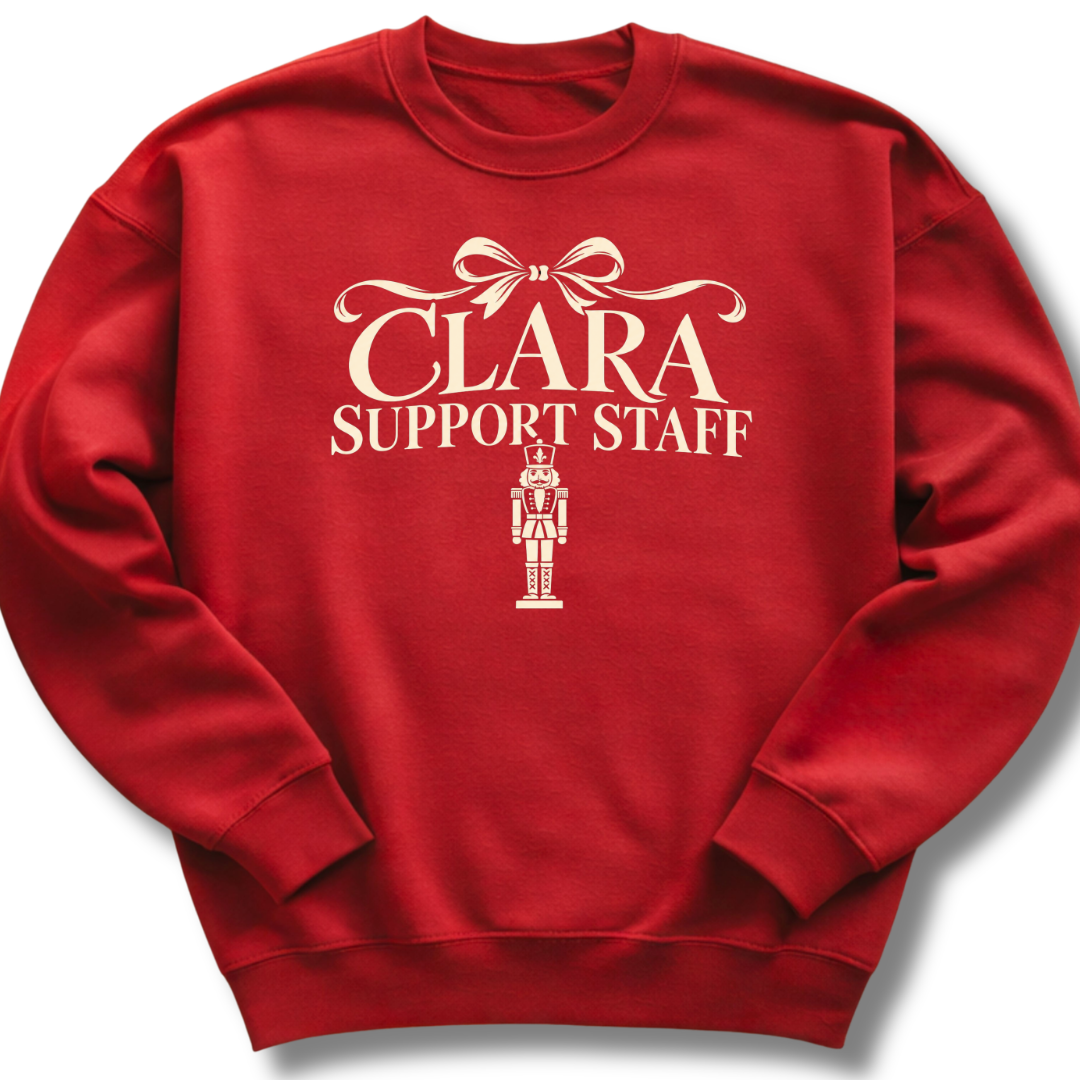 A red crewneck sweatshirt featuring a 'Clara Support Staff' Nutcracker graphic.