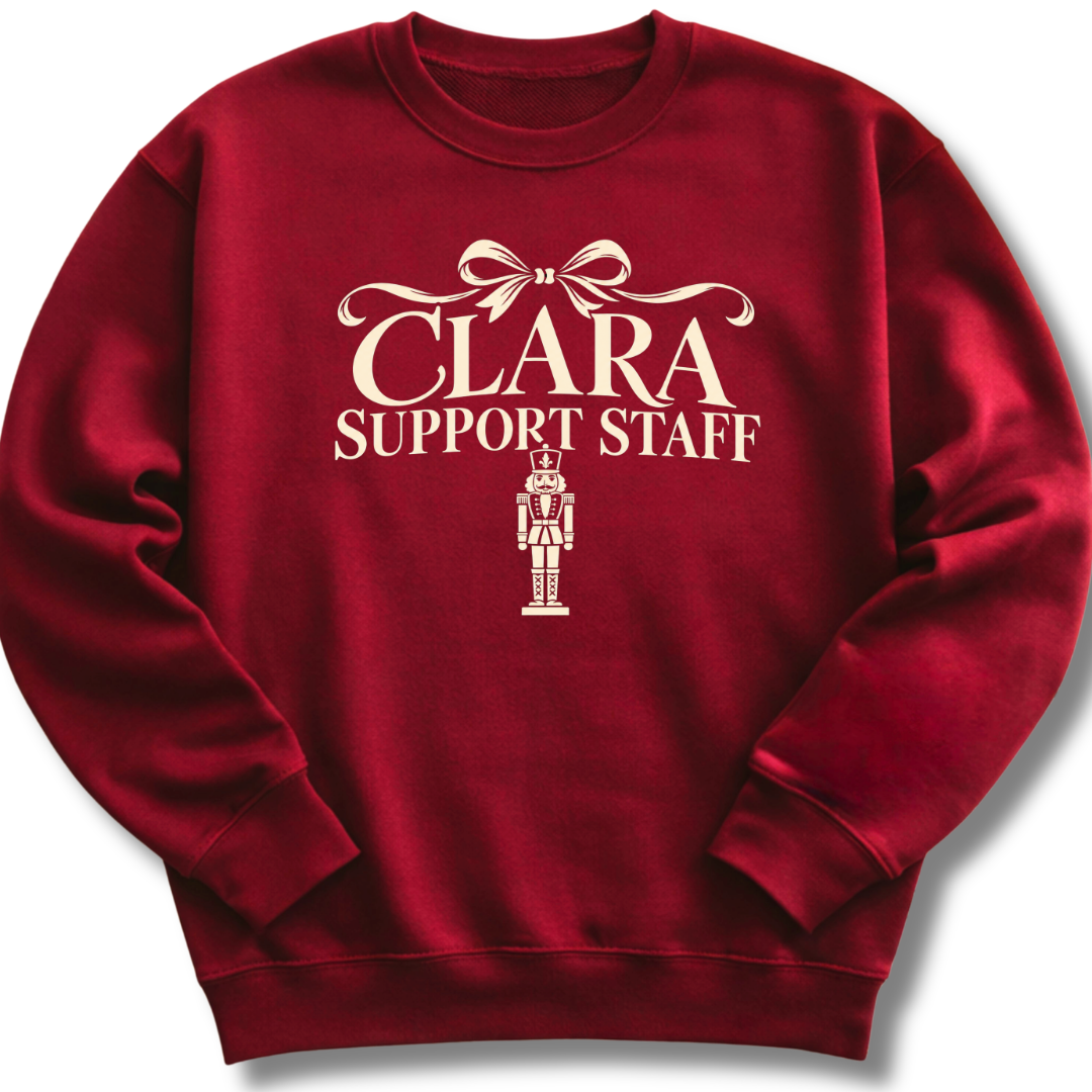 A maroon crewneck sweatshirt featuring a 'Clara Support Staff' Nutcracker graphic.