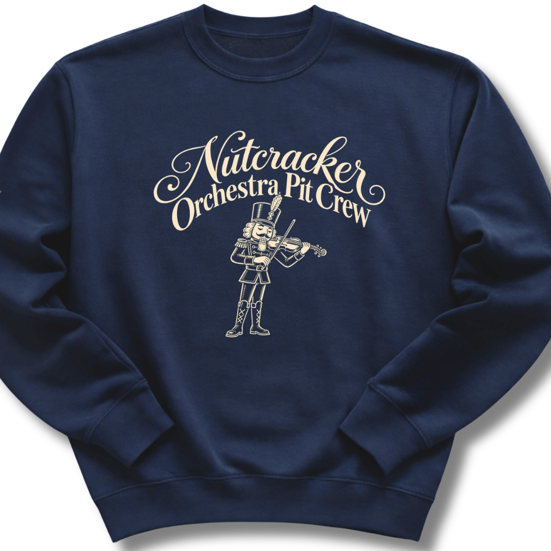 A navy crewneck sweatshirt featuring a 'Nutcracker Orchestra Pit Crew' design with a classic nutcracker and elegant script lettering.