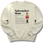 A sand-colored crewneck sweatshirt featuring a dictionary-style definition of 'Nutcracker Mom'.