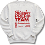 A light ash gray crewneck sweatshirt featuring a vintage-inspired red 'Nutcracker Prep Team' design.