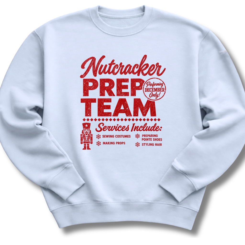 A light blue crewneck sweatshirt featuring a vintage-inspired red 'Nutcracker Prep Team' design.