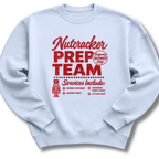 A light blue crewneck sweatshirt featuring a vintage-inspired red 'Nutcracker Prep Team' design.