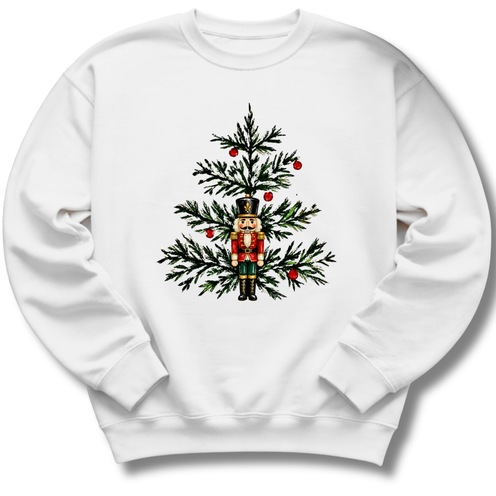 A white youth crewneck sweatshirt featuring a nutcracker nestled among evergreen branches and bright red winter berries.