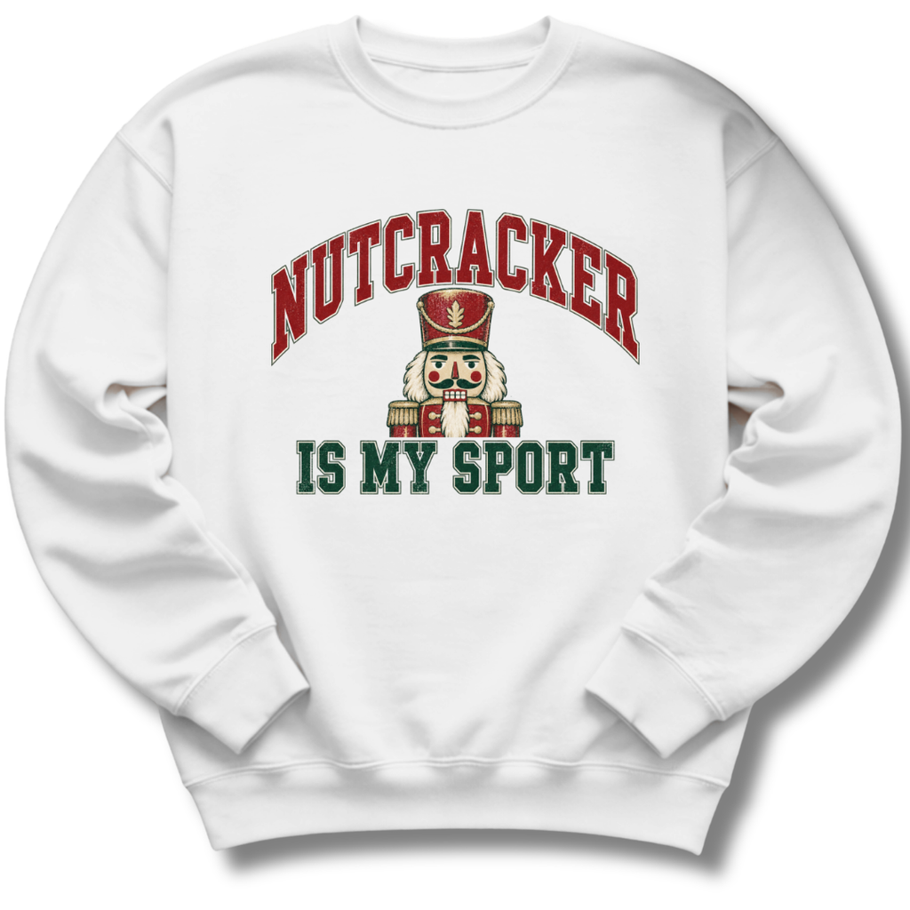 A white crewneck sweatshirt featuring a playful nutcracker graphic with the words 'Nutcracker Is My Sport'.
