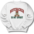 A white crewneck sweatshirt featuring a playful nutcracker graphic with the words 'Nutcracker Is My Sport'.