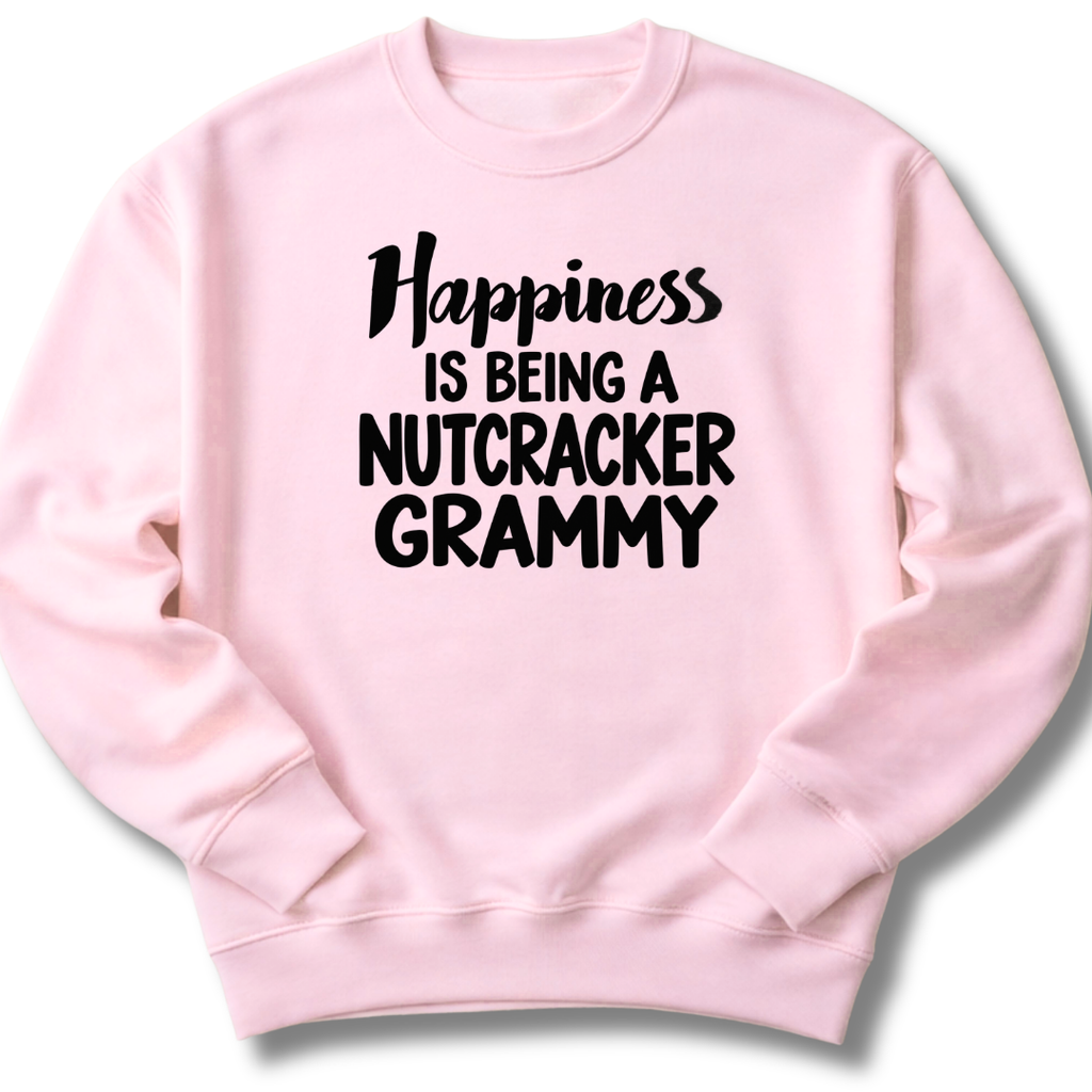 A light pink crewneck sweatshirt featuring a 'Happiness Is Being a Nutcracker Grammy' holiday design.