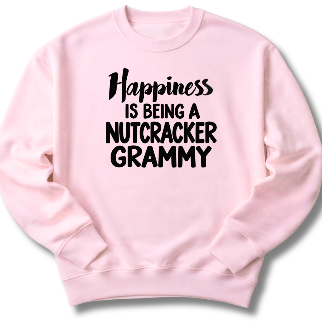 A light pink crewneck sweatshirt featuring a 'Happiness Is Being a Nutcracker Grammy' holiday design.