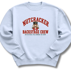 A light blue crewneck sweatshirt featuring a vintage-inspired nutcracker with 'Backstage Crew' lettering.