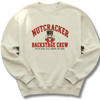 A sand-colored crewneck sweatshirt featuring a vintage-inspired nutcracker with 'Backstage Crew' lettering.