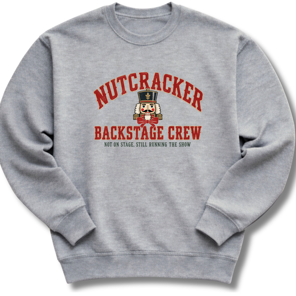 A heather gray crewneck sweatshirt featuring a vintage-inspired nutcracker with 'Backstage Crew' lettering.