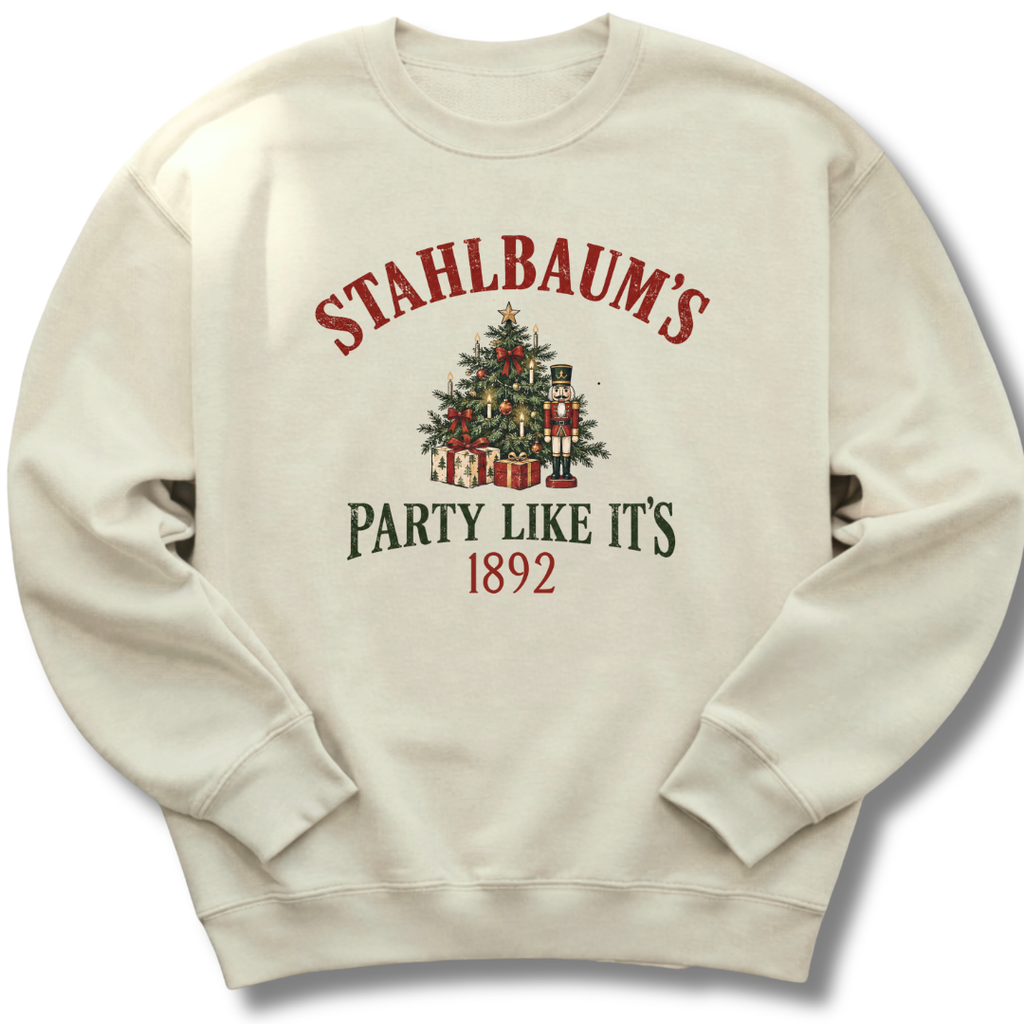 A sand-colored crewneck sweatshirt featuring a vintage-inspired Christmas tree with the message 'Stahlbaum's Party Like It's 1892'.