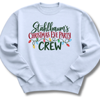 A light blue crewneck sweatshirt featuring festive 'Stahlbaum's Christmas Eve Party Crew' lettering accented with colorful holiday lights.