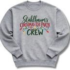 A heather gray crewneck sweatshirt featuring festive 'Stahlbaum's Christmas Eve Party Crew' lettering accented with colorful holiday lights.