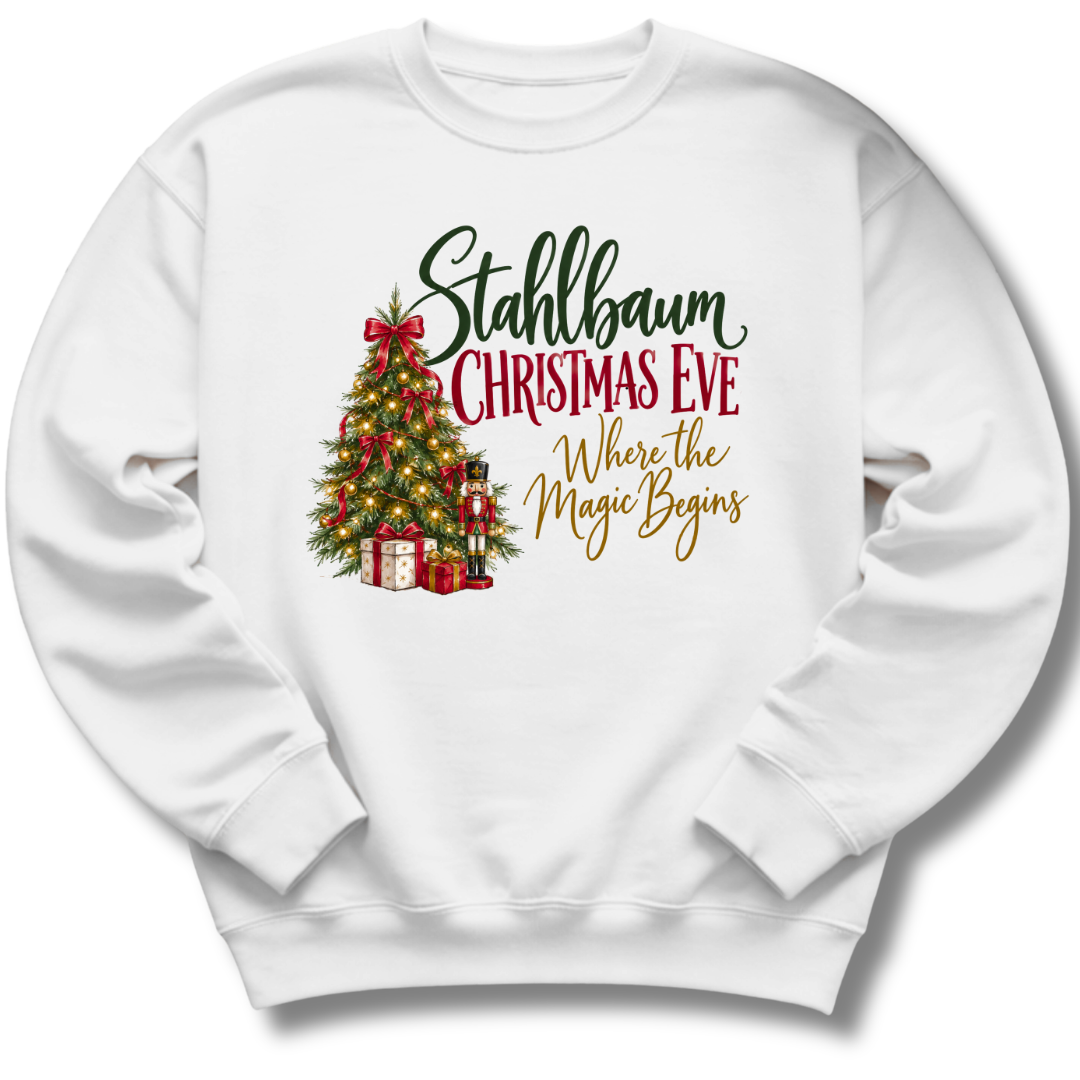 A white crewneck sweatshirt featuring a decorated vintage-style Christmas tree with the words 'Stahlbaum Christmas Eve, Where the Magic Begins'.
