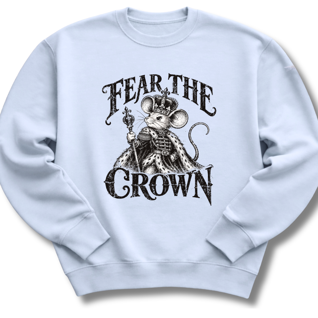 A light blue crewneck sweatshirt featuring a crowned, sword-bearing mouse in detailed black artwork beneath the words 'FEAR THE CROWN'.