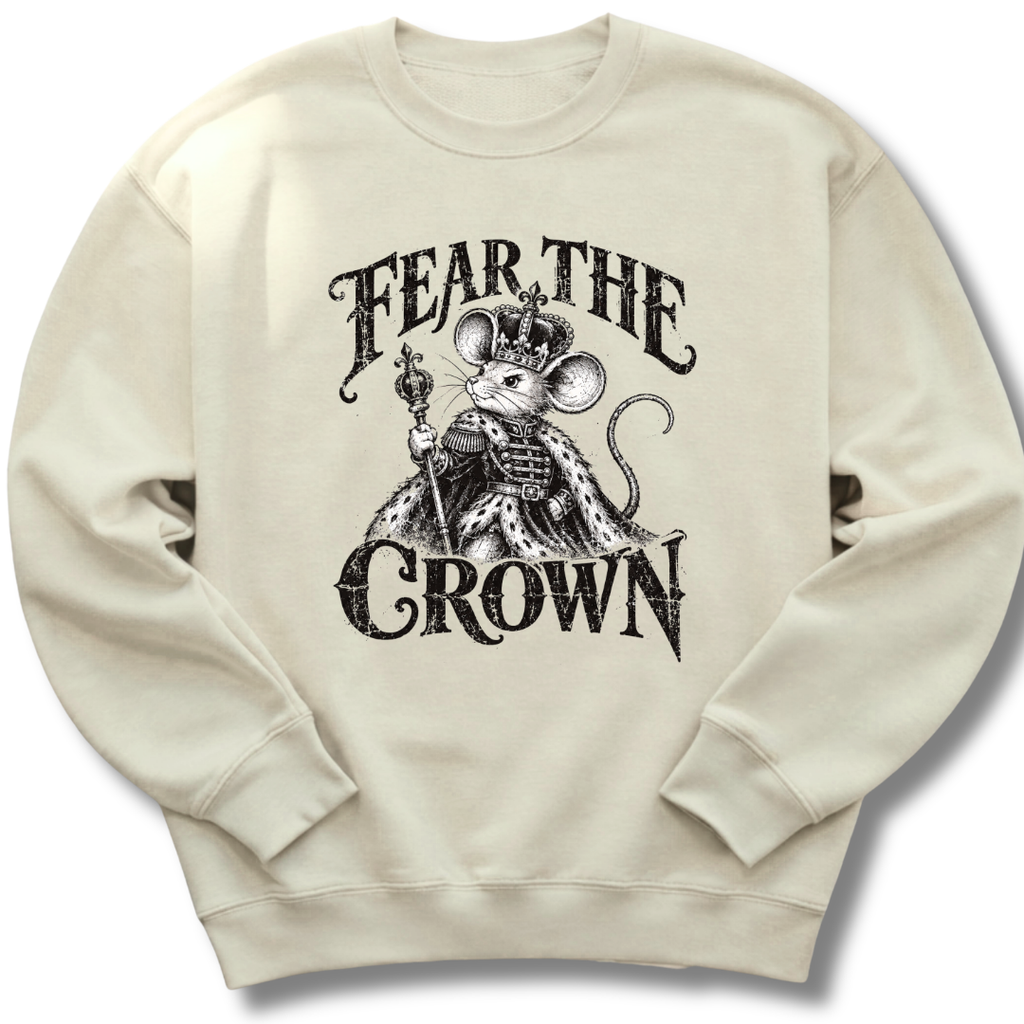 A sand-colored crewneck sweatshirt featuring a crowned, sword-bearing mouse in detailed black artwork beneath the words 'FEAR THE CROWN'.