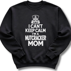A black crewneck sweatshirt featuring a bold white design with a crowned nutcracker and the message 'I Can't Keep Calm, I'm a Nutcracker Mom'.