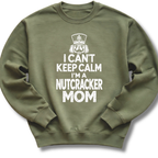 A military green crewneck sweatshirt featuring a bold white design with a crowned nutcracker and the message 'I Can't Keep Calm, I'm a Nutcracker Mom'.