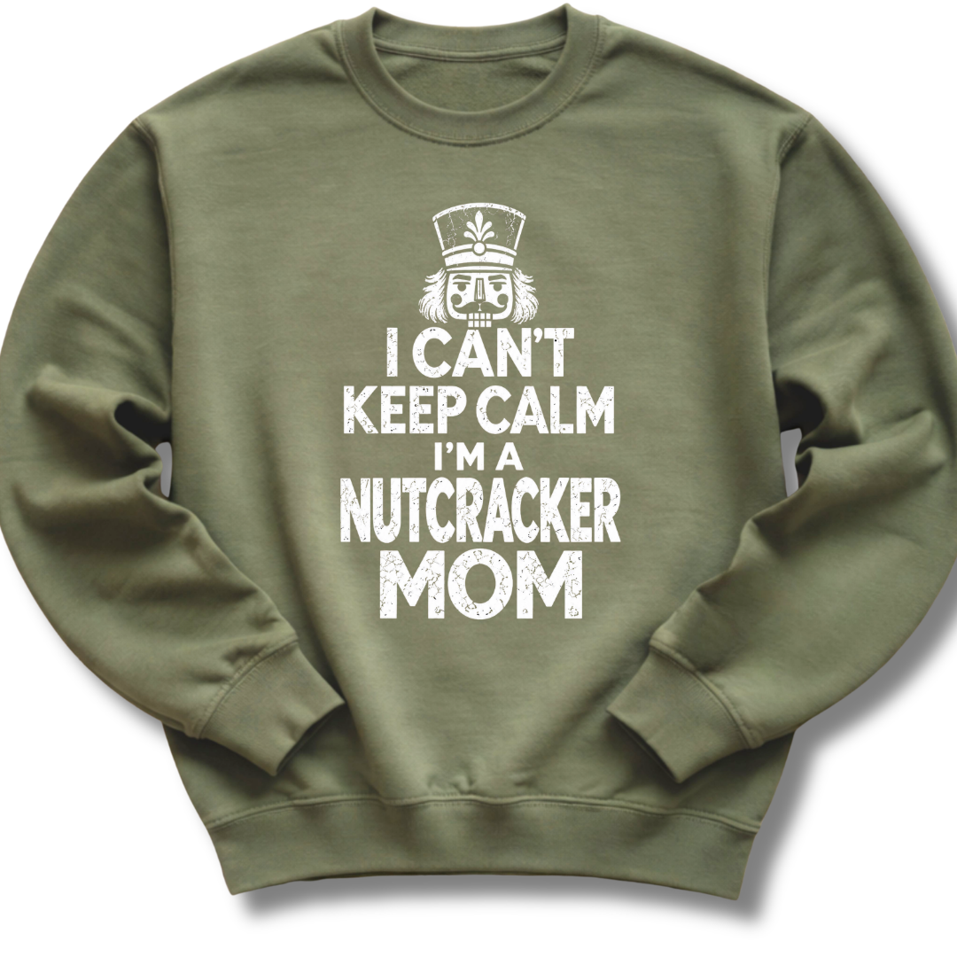 A military green crewneck sweatshirt featuring a bold white design with a crowned nutcracker and the message 'I Can't Keep Calm, I'm a Nutcracker Mom'.