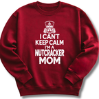A maroon crewneck sweatshirt featuring a bold white design with a crowned nutcracker and the message 'I Can't Keep Calm, I'm a Nutcracker Mom'.