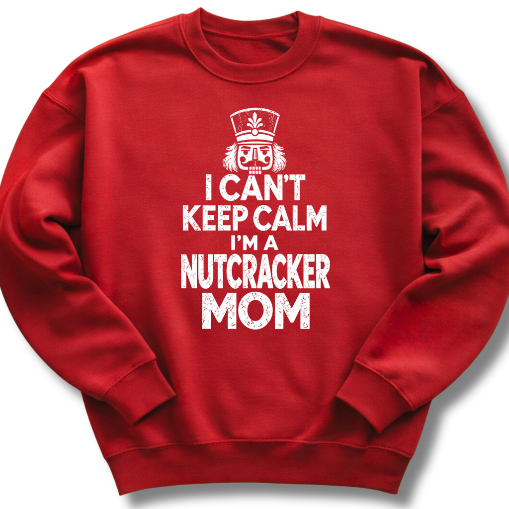 A red crewneck sweatshirt featuring a bold white design with a crowned nutcracker and the message 'I Can't Keep Calm, I'm a Nutcracker Mom'.