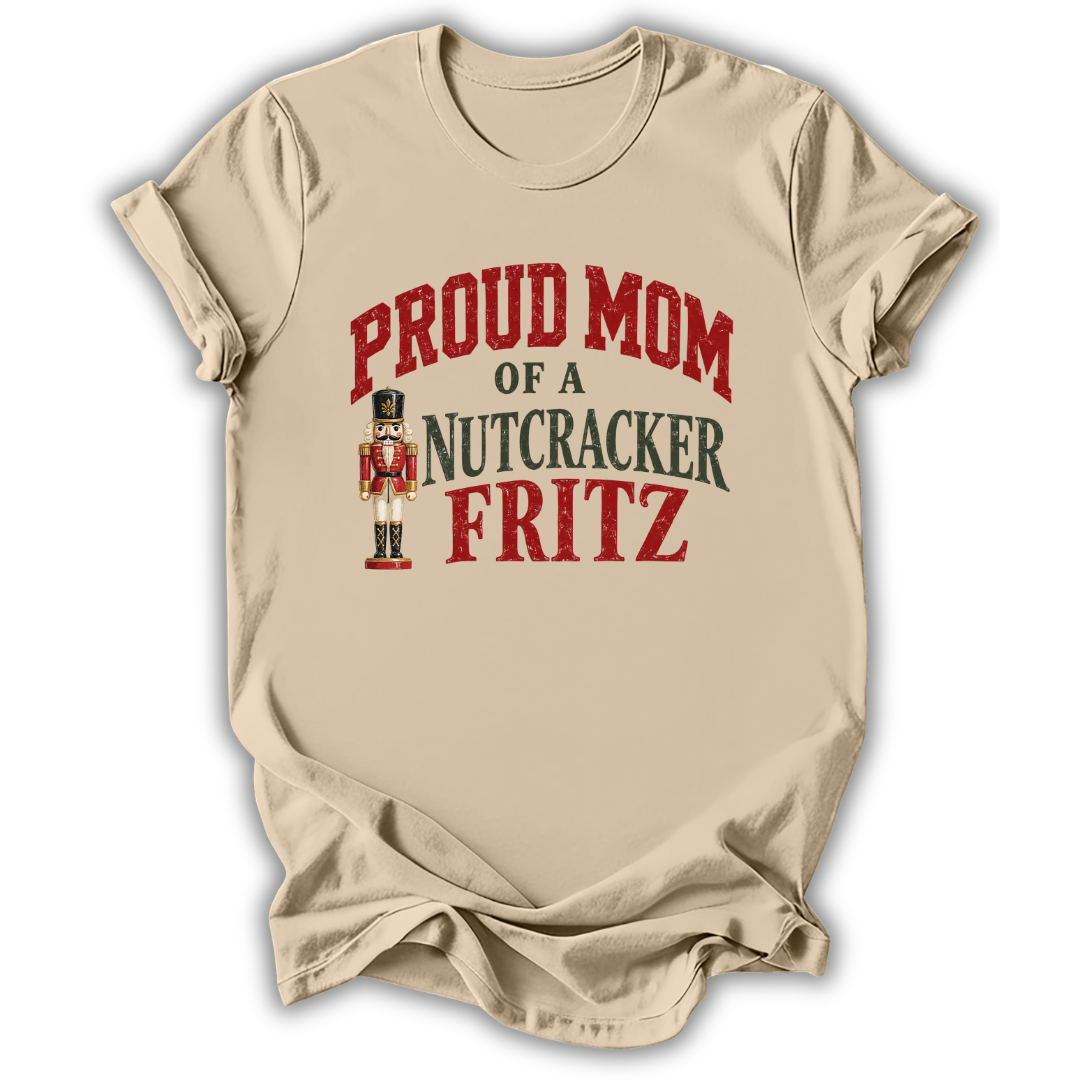 A sand beige short-sleeve t-shirt printed with the “Mom of a Nutcracker Fritz” graphic design.