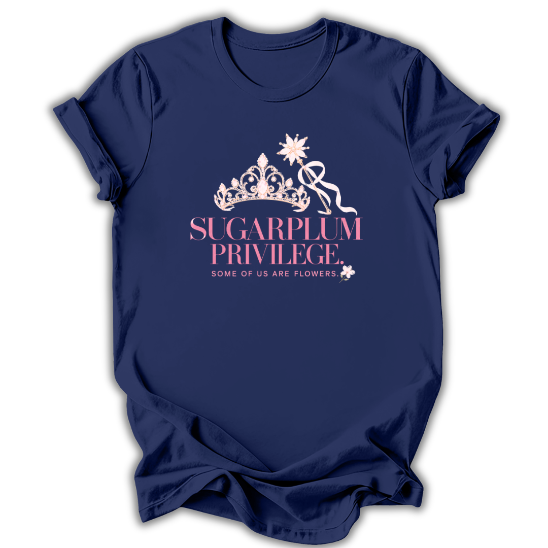 A navy blue short-sleeve t-shirt with a graphic on the front featuring a white crown, a pink ribbon, and the text 'SUGARPLUM PRIVILEGE' and 'SOME OF US ARE FLOWERS' in pink and white.