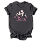 A dark charcoal gray t-shirt with a pink graphic on the front featuring a crown, a ribbon, and the text 'SUGARPLUM PRIVILEGE' and 'SOME OF US ARE FLOWERS'.