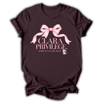 A dark chocolate brown short-sleeve t-shirt printed with the “Clara Privilege” graphic design.