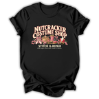 A black short-sleeve t-shirt printed with the “Nutcracker Costume Shop” graphic design.