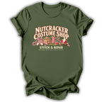 A military green short-sleeve t-shirt printed with the “Nutcracker Costume Shop” graphic design.