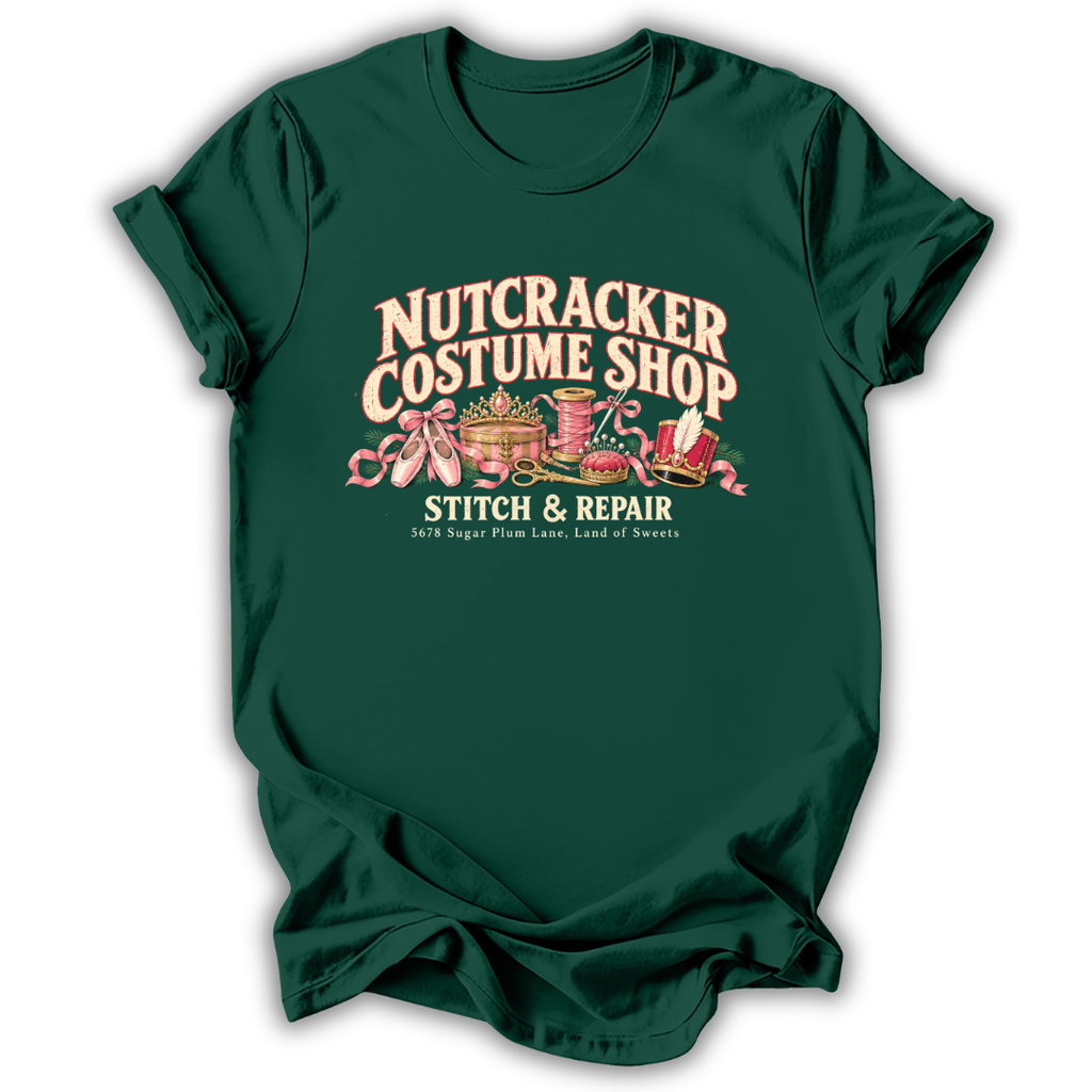 A forest green short-sleeve t-shirt printed with the “Nutcracker Costume Shop” graphic design.