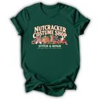 A forest green short-sleeve t-shirt printed with the “Nutcracker Costume Shop” graphic design.