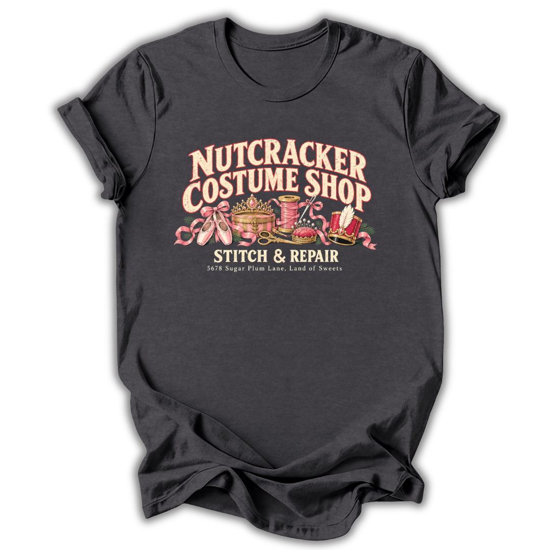 A dark heather gray short-sleeve t-shirt printed with the “Nutcracker Costume Shop” graphic design.
