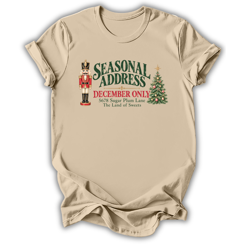 A sand beige short-sleeve t-shirt printed with the “Seasonal Address” graphic design.
