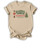 A sand beige short-sleeve t-shirt printed with the “Seasonal Address” graphic design.