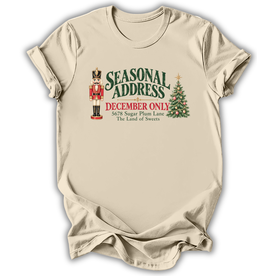 A natural cream short-sleeve t-shirt printed with the “Seasonal Address” graphic design.