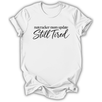 A white short-sleeve t-shirt printed with the “Still Tired Nutcracker Mom” graphic design.